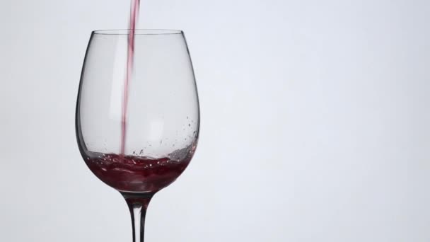 Wine is pouring into a glass from a bottle.Slow motion - Video, Çekim