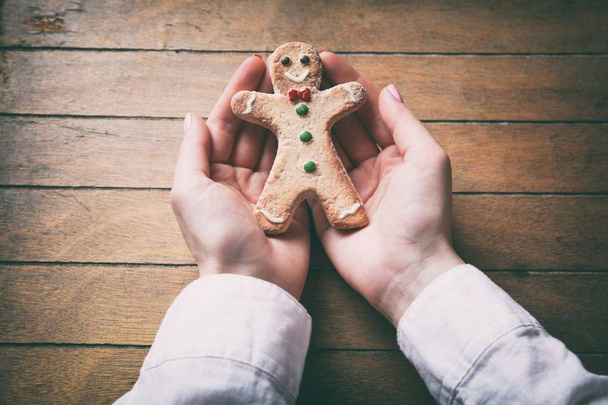 hands holding christmas gingerbread man cookie - Photo, Image