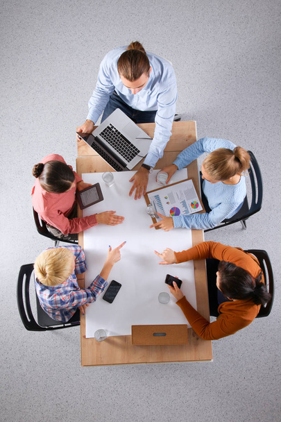 Business people sitting and discussing at meeting, in office - Photo, image