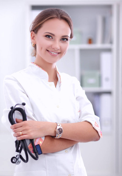 Woman doctor standing at hospital with medical stethoscope - Foto, Imagen