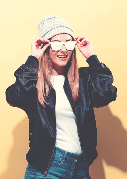 Girl in trendy painted glasses in black jacket - Fotó, kép