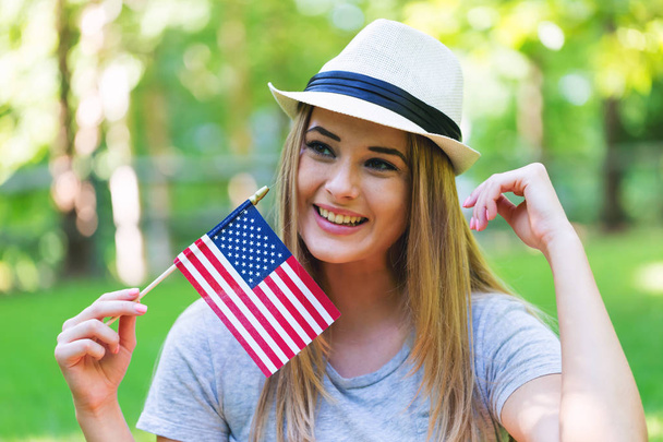 GIrl with an American flag on the fourth of July - Foto, imagen
