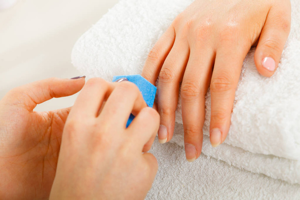 Woman getting manicure done file nails - Foto, Bild