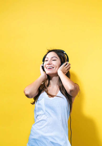 Happy young woman with headphones - Fotó, kép