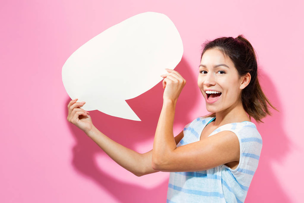 Young woman holding a speech bubble - Photo, Image