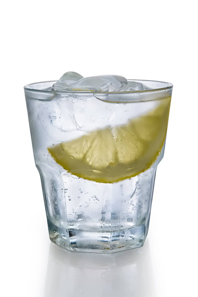 Misted glass of water with ice and slice of lemon - Photo, image