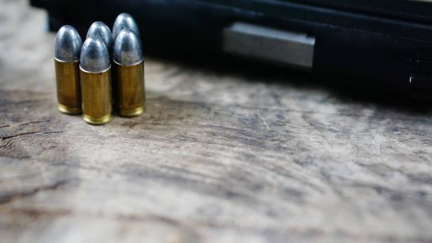 Bullets and gun on the wood - Photo, image