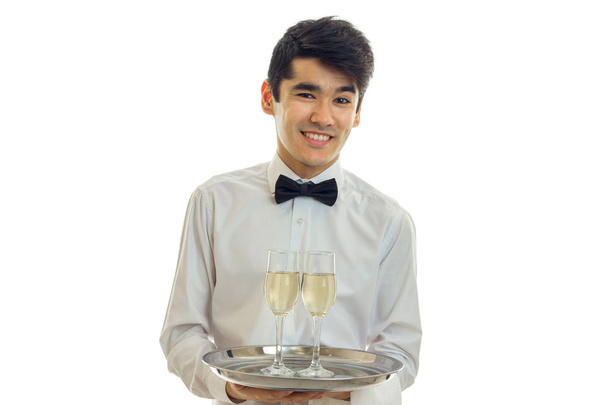 horizontal portrait of the beautiful smiling waiter with glasses of wine isolated on a white background - Fotoğraf, Görsel
