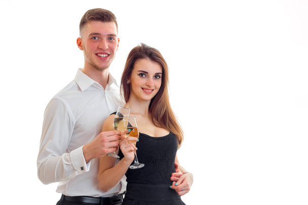 smiling couple posing in the Studio and holding wine glasses - Foto, afbeelding