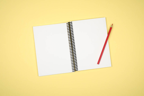 Top view of open spiral blank notebook on colorful desk - Photo, Image