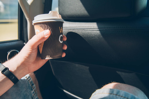 man passenger drink coffe in car - Foto, Imagen