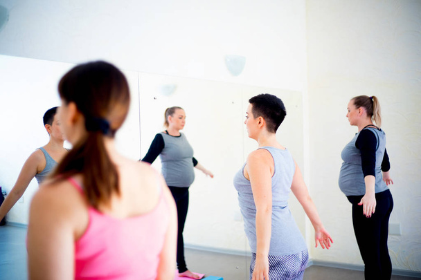 Pregnant women do fitness exercises - Foto, imagen