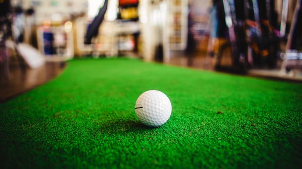 Golf club and ball in grass - 写真・画像