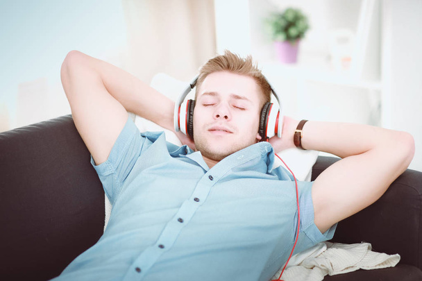 Man listening music with headphones at home - Photo, Image