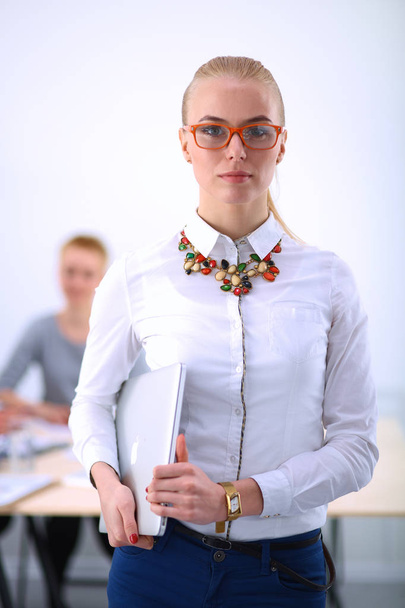 Portrait of a young woman working at office standing - Foto, Imagem