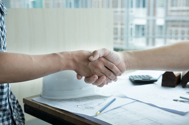 Architect and customer shaking hands at workplace. Engineer hand - Photo, Image