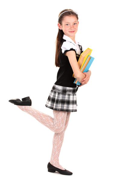 beautiful little girl in school uniform with books isolated on white - Valokuva, kuva