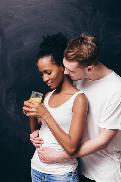 Interracial couple. Togetherness, hug and care - 写真・画像