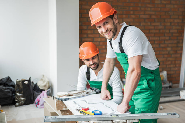 Hilarious busy constructors repairing apartment - Foto, immagini