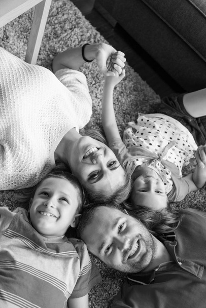 happy family lying on the floor - Фото, зображення