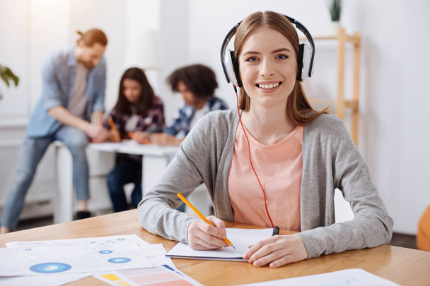 Admirable dedicated student using audio lessons for self education - Foto, Bild