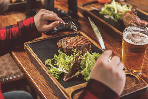 Appetizing succulent meat on wooden table - Fotó, kép