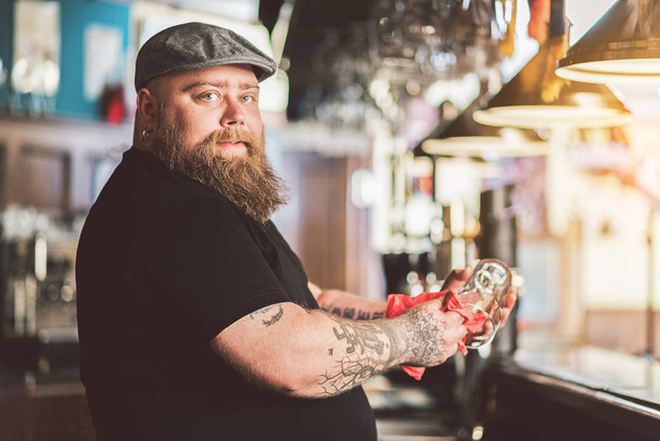 Adult bearded guy standing at bar counter - Fotoğraf, Görsel