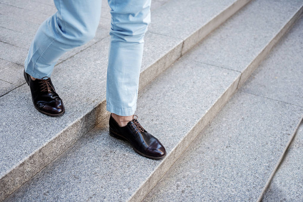 Active stylish male person going on steps - Fotó, kép