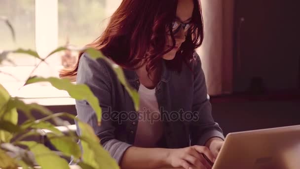 Red haired freelancer woman working on laptop. - Felvétel, videó