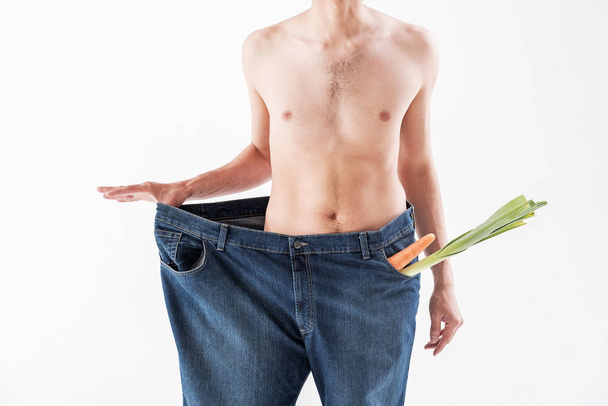 Slender young man sticking to the vitamin diet - Фото, зображення