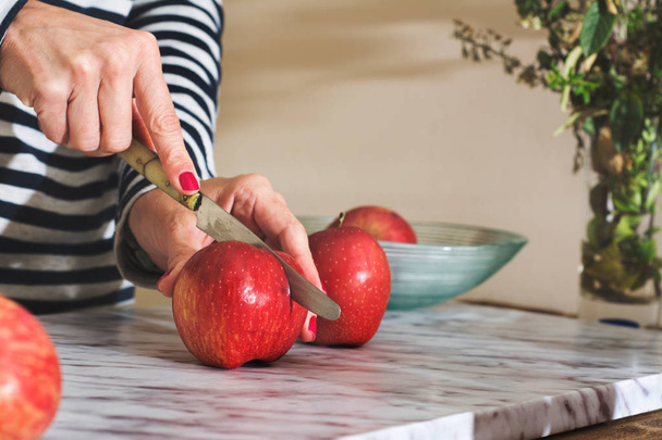 Woman cutting apples on the table - Photo, Image