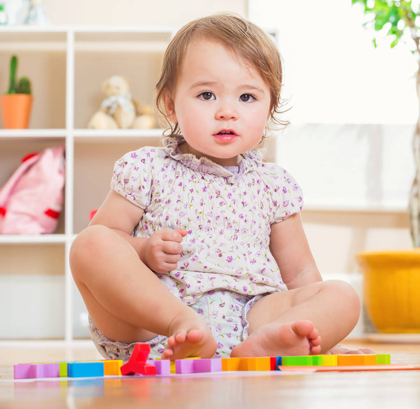 Happy toddler girl playing with her toys  - Valokuva, kuva