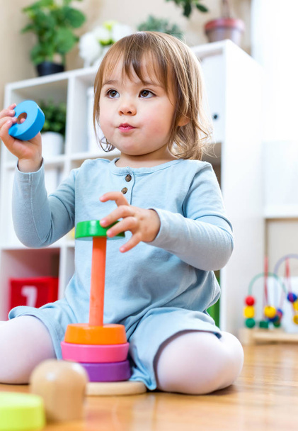 Toddler girl playing with toys - Fotoğraf, Görsel