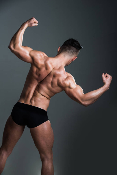 athlete with muscular body and back in underwear pants - Фото, зображення