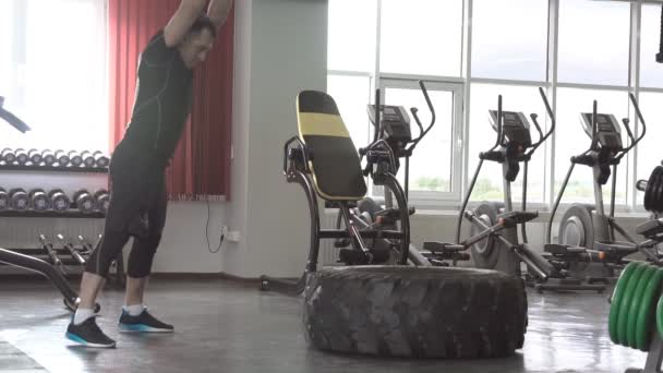 Sport Fitness Man raken wiel band met hamer slee in de sportschool - Video