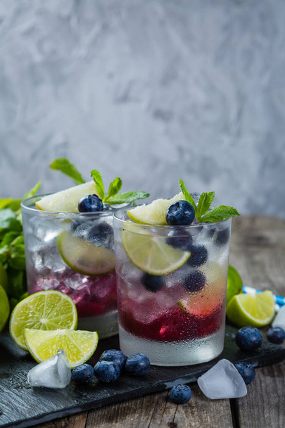 Blueberry mojito on rustic wood background - Foto, imagen