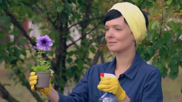 Girl in yellow work safety gloves with plant. - Materiał filmowy, wideo