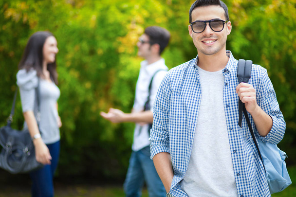 Male student outdoors smiling  - Foto, Bild