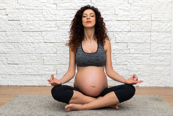 Pregnant woman doing yoga - Valokuva, kuva