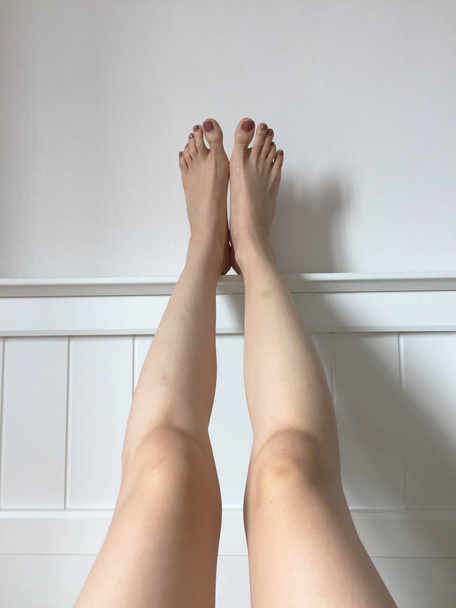 Female Feet with Brown Nail looking up, Raised Straight Up in Bedroom - Zdjęcie, obraz