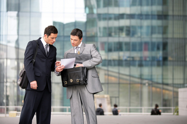 Two businessmen checking a document - Foto, imagen
