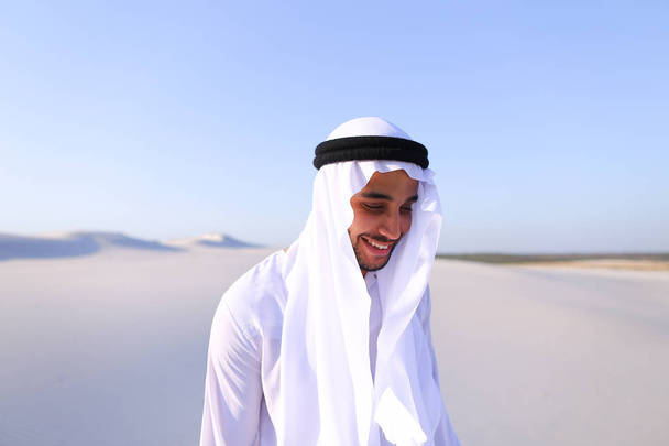 Young male emirate rejoices in life and walks through expanses o - Photo, Image