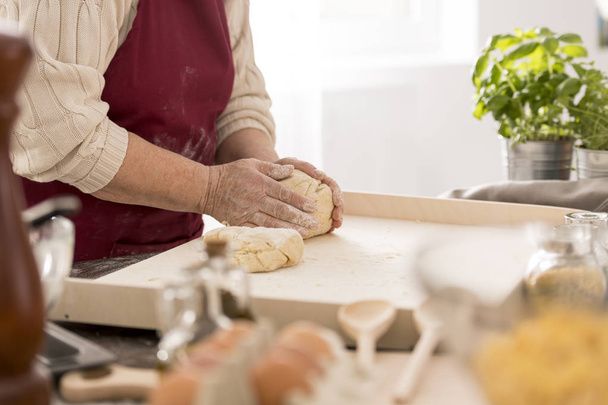 Senior woman preparing fresh pasta - Fotó, kép
