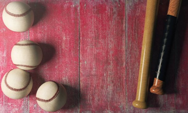 Top view of baseballs and bats on aged red wood surface with copy space.  - Foto, afbeelding