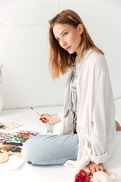 Young caucasian lady painter at workspace - Photo, Image