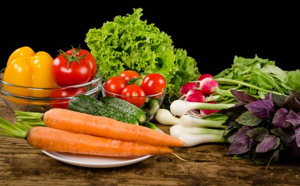 Plenty of vegetables on rustic wooden table - Foto, immagini