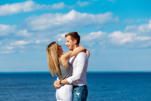 Young couple enjoying themselves on a beach . Romantic couple in love - Photo, Image