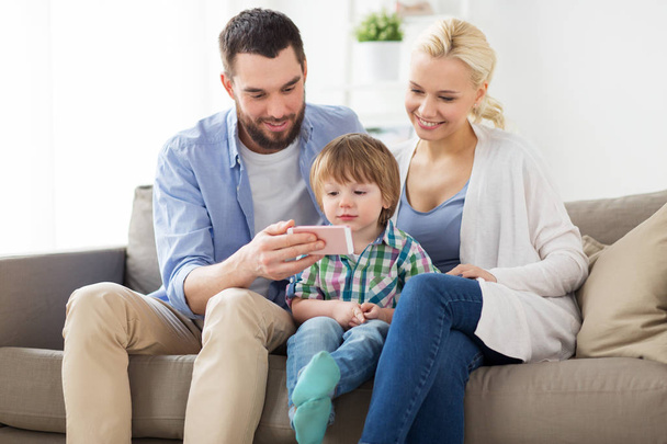 happy family with smartphone at home - Φωτογραφία, εικόνα