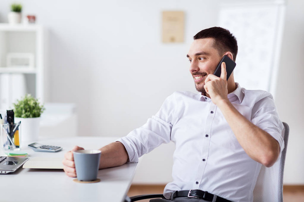 businessman calling on smartphone at office - Photo, Image