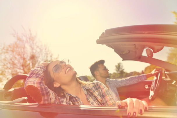 Couple of lovers driving on a convertible car - Newlywed pair on a romantic date - Photo, Image